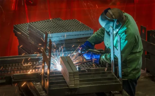 Man welding steel grates